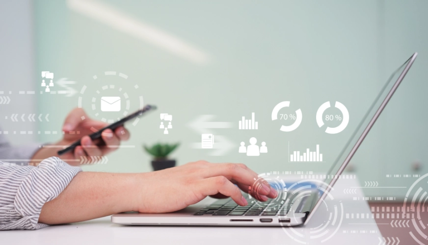 La accesibilidad desde cualquier dispositivo y lugar aumenta el compromiso Ilustración de una mano trabajando con un portatil, mostrando las diferentes opciones que puede tener un CRM a medida